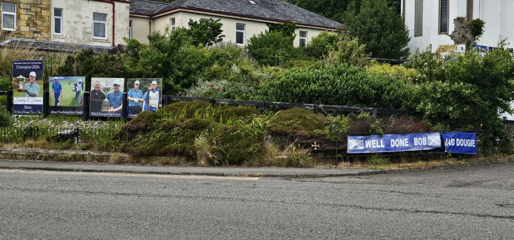 Congratulations signs for a winner of a golf tournament, with his name on one banner and 'and dougie' on another banner