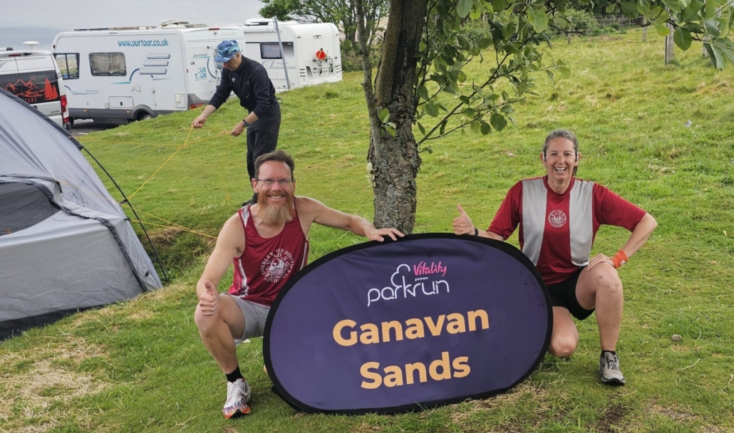 Us with the parkrun sign for Ganavan Sands 
