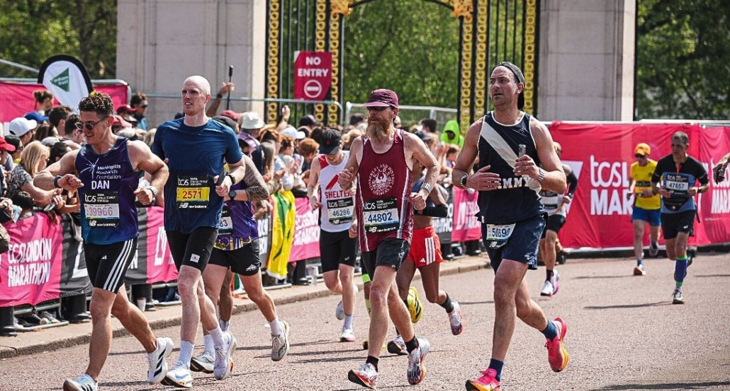 Jason running with along the Mall at the London Marathon