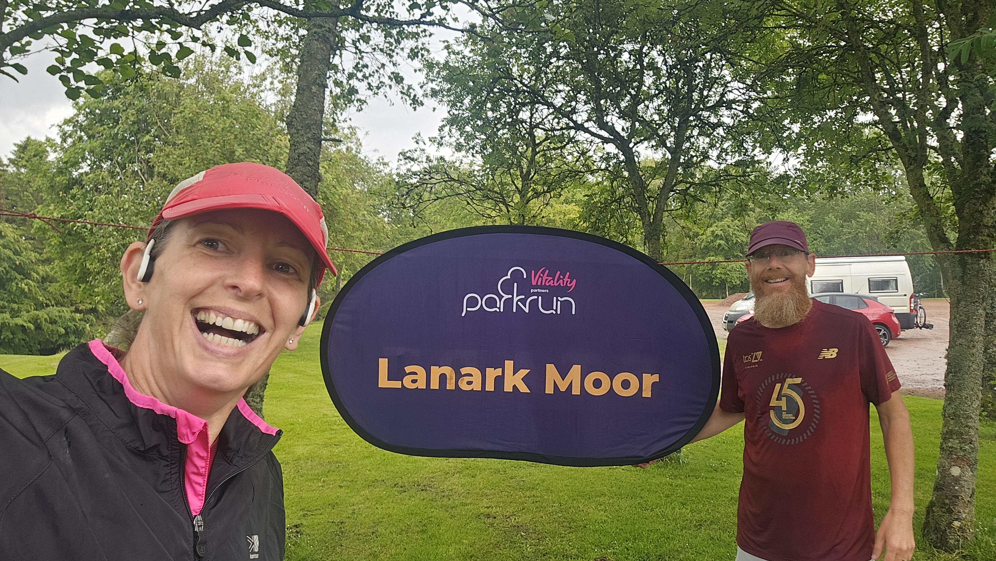 Ju and Jay at Lanark Moor parkrun sign