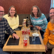 Four people sitting around a table in a restaurant