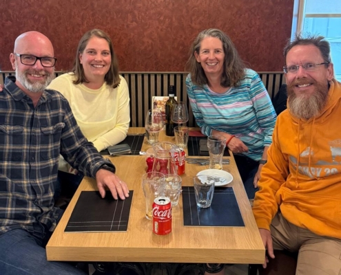 Four people sitting around a table in a restaurant