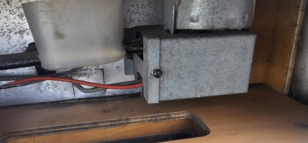 View from inside our motorhome's lower fridge vent. The burner, thermocouple and ignitor all sit in the metal box
