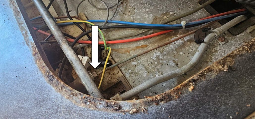 The thermocouple screwed into the gas control valve on the top of our Hymer's fridge (hob lifted for access)