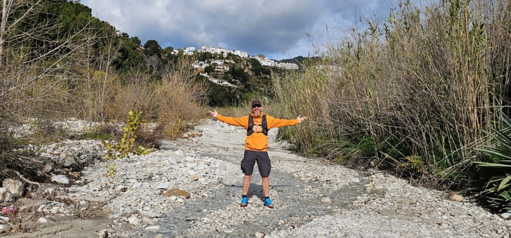 Man walking in dry riverbed