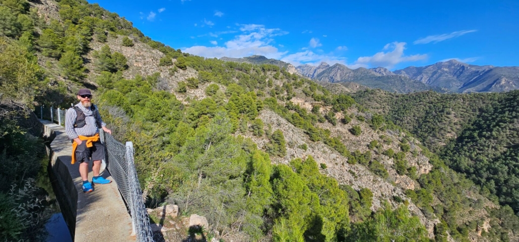 Man hiking along an acequia, water course in Spain