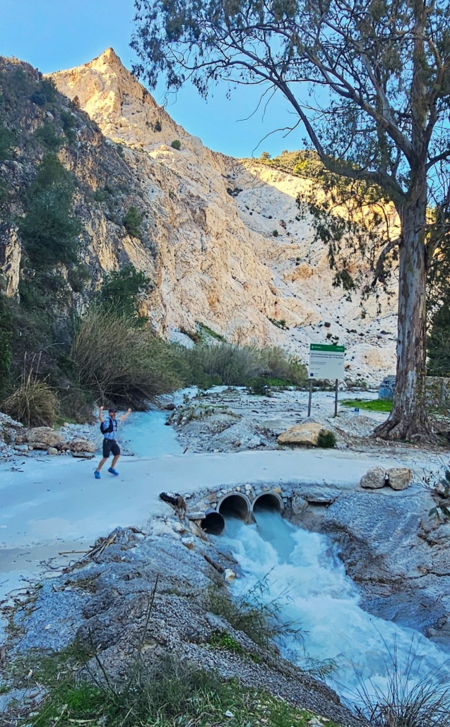 Man by bridge over river