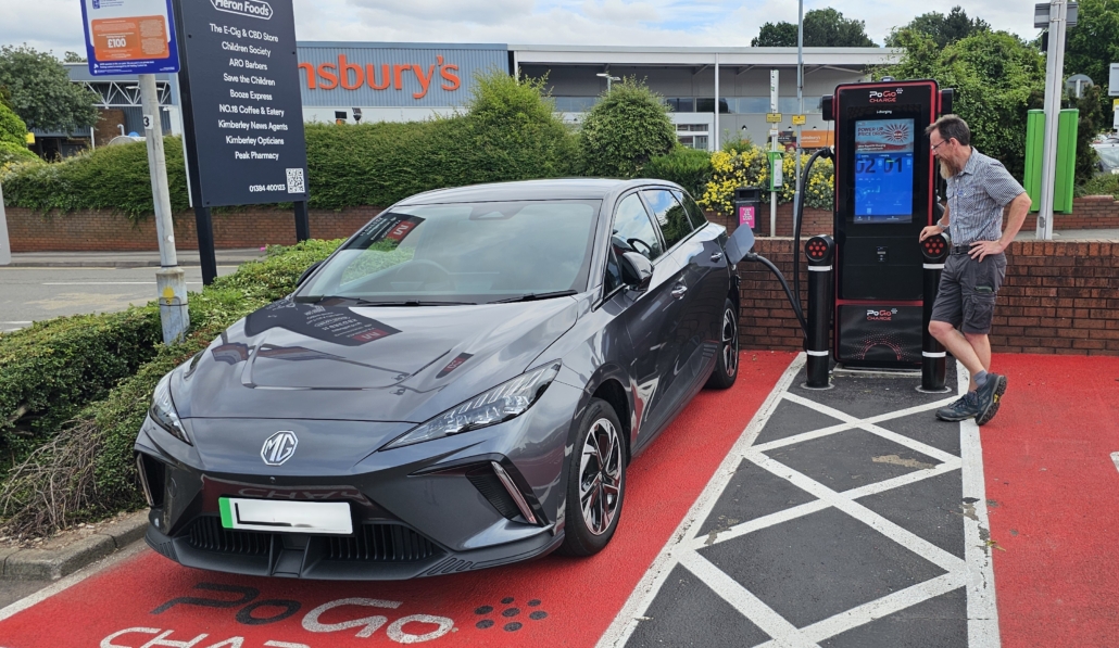 Grey MG4 car parked in public charging bay with Jay looking perplexed