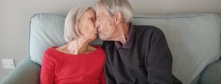 Ju's Mum and Dad sharing a kiss